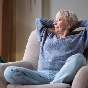 Woman relaxing in her favorite armchair and smiling