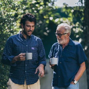 Man and son enjoying a walk and talk with coffee