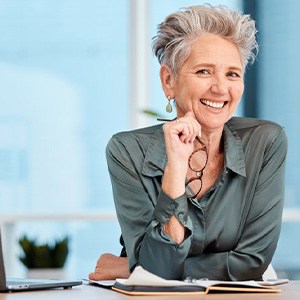 Woman smiling at her work desk