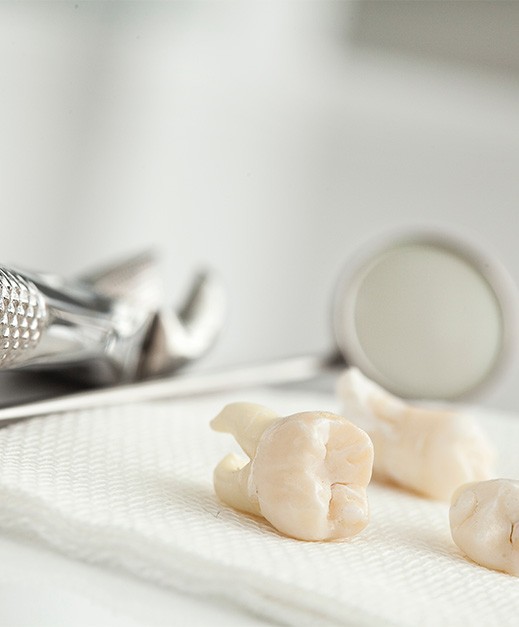 Close up of extracted teeth on a white cloth