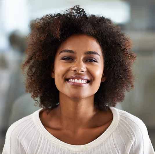 Woman smiling after tooth extraction in Columbus