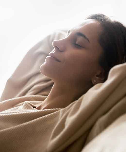 Woman with her head propped after tooth extraction