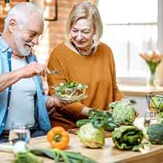 A cheerful senior couple eating healthy foods